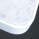 <p>White marble<br />
Circular tables have<br />
a square polished edge</p>
